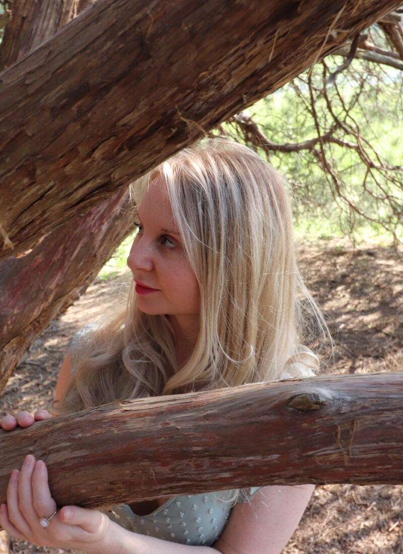 Photography of Stephanie poses near a tree